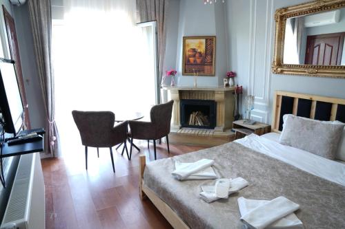 a bedroom with a bed and a table and a fireplace at Destina Hotel Agva in Şile