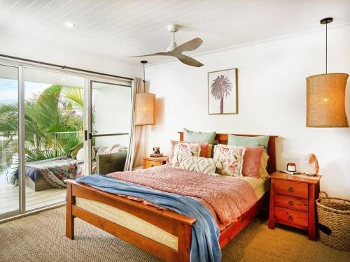 a bedroom with a bed and a large window at Elanora 3 bedroom apartment in Gold Coast