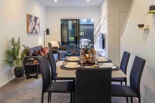 a dining room and living room with a table and chairs at 4 Minutes walk to Riverside Market!4bed 4 bath in Christchurch