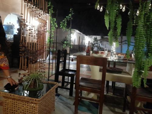 a dining room with a table and chairs and plants at Montemar Apart Hotel - Playa Huanchaco in Huanchaco