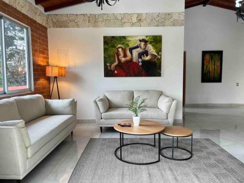 a living room with a couch and a table at Palos altos house Poblado 6 min to Provenza in El Poblado
