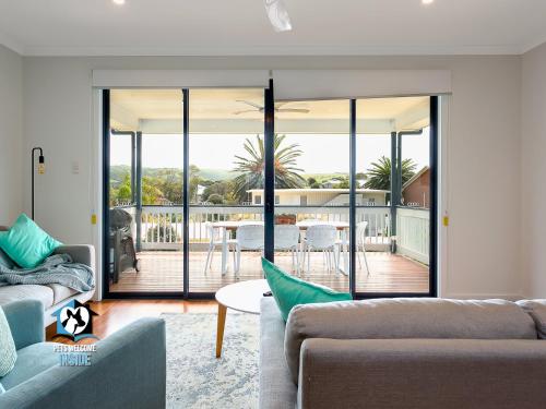 a living room with a view of a patio at 4BR Contemporary Coastal Home with Rural Outlook in Port Elliot