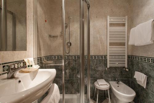 a bathroom with a sink and a shower at Hotel Al Ponte Mocenigo in Venice
