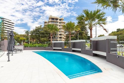 a swimming pool on the roof of a building at Cove 701 in Forster