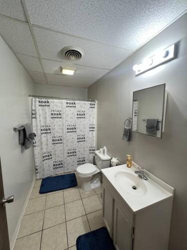 a bathroom with a sink and a toilet and a mirror at Spacious 3BR-3BA, Downtown Morgantown, Near WVU in Morgantown