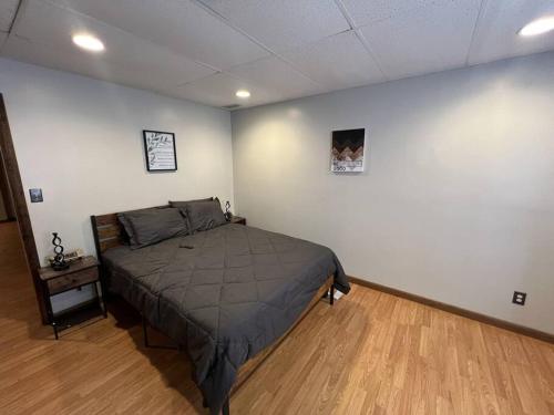 a bedroom with a bed and a wooden floor at Spacious 3BR-3BA, Downtown Morgantown, Near WVU in Morgantown