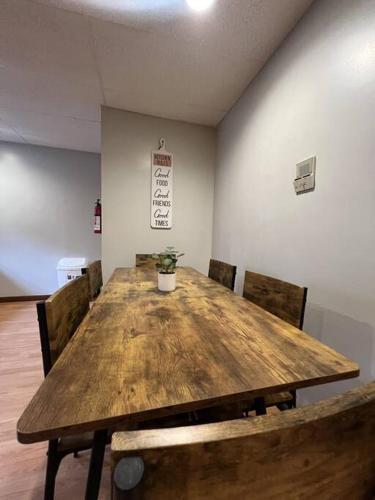 a large wooden table with chairs and a potted plant at Spacious 3BR-3BA, Downtown Morgantown, Near WVU in Morgantown