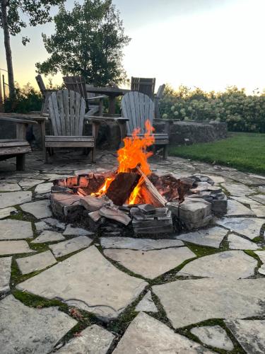 a fire pit in a yard with two chairs at Drift in Goderich