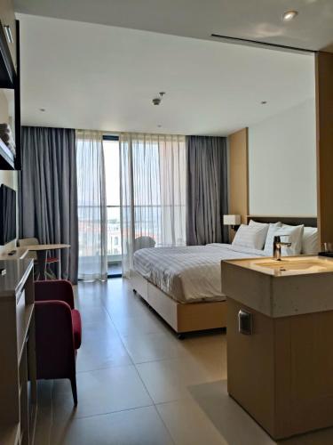 a hotel room with a bed and a sink at The Arena Sunrise Cam Ranh in Thôn Hòa Ða