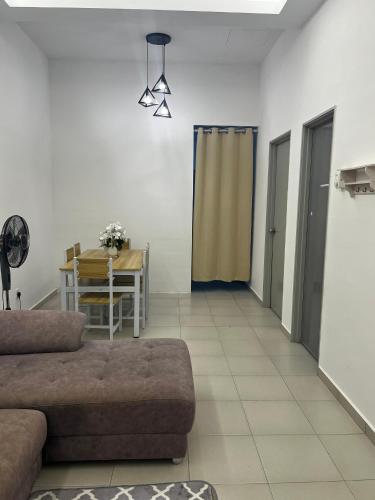 a living room with a couch and a table at Bayu Laut Homestay (Anjung Gapam) in Bemban