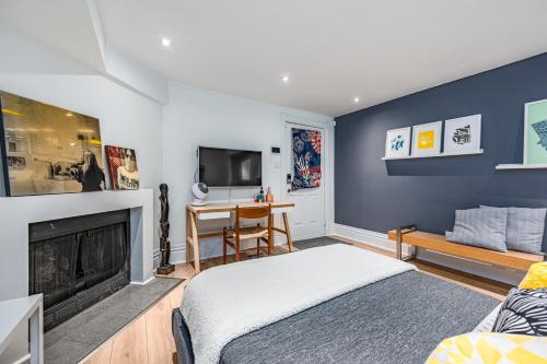a bedroom with a bed and a fireplace and a tv at Modern Design Studio in Toronto