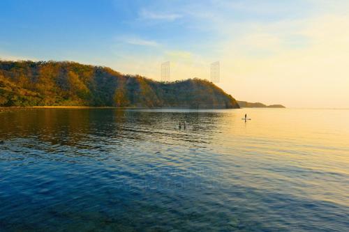 a large body of water with a boat in it at PICO DE LORO Pool Accessible CAROLA 3 Bedroom Units by SEE Condominiums in Cutad