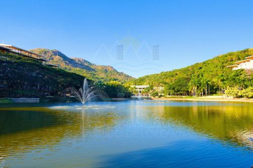a lake with a fountain in the middle of it at PICO DE LORO Pool Accessible CAROLA 3 Bedroom Units by SEE Condominiums in Cutad