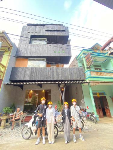 a group of people standing in front of a building at Ethnic House Jr in Dồng Văn