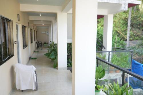 a hallway of a house with a table and chairs at This is it Beachfront - Rooms, Cafe & Events in Arambol