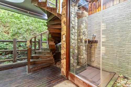 a walk in shower on a wooden deck at Pandora Vista Retreat in Zhangjiajie