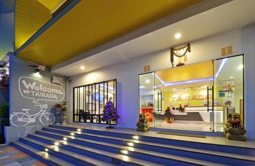 a store front with blue stairs in front of it at Tairada Boutique Hotel in Krabi town