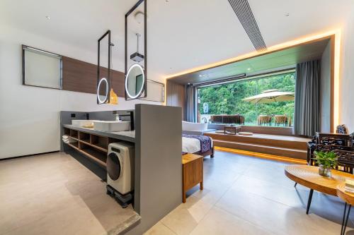 a room with a bed and a bathroom with a sink at Pandora Vista Retreat in Zhangjiajie