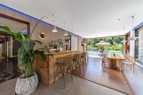 a bar in a house with a potted plant at Pandora Vista Retreat in Zhangjiajie