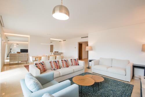 a living room with two couches and a table at Estoril Biarritz - Luxury Sea View - Center Apart in Estoril