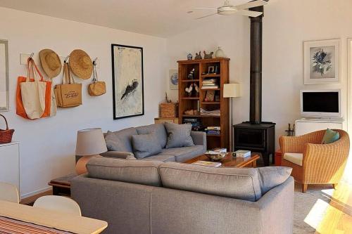 a living room with a couch and a stove at Green Bush Haven in Muckleford South