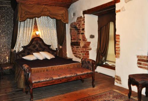 a bedroom with a bed and a fireplace at St. Peterburg in Pärnu
