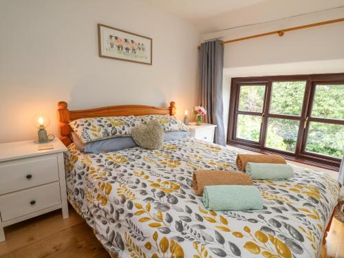 Un pat sau paturi într-o cameră la Fisherman's Cottage