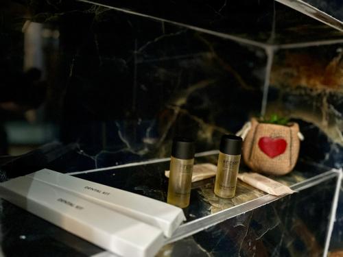 a shelf with three bottles of essential oils on it at BlackMountain Hotel in Kolgecaj