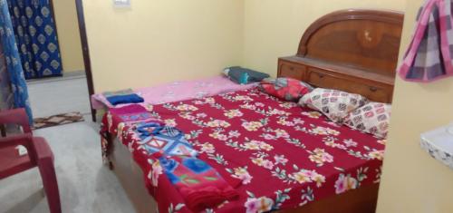 a bedroom with a bed with a red comforter at Two BHK Fully Furnished Flat - Near Charminar and Salar Jung Museum in Hyderabad