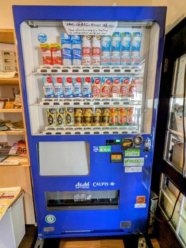 a vending machine filled with bottles of soda at Pension Cotton Farm in Niseko