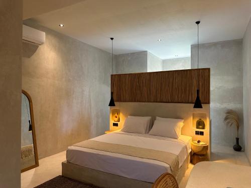 クタにあるKalima Hotel Boutiqueのベッドルーム1室(大型ベッド1台、上部にライト付)