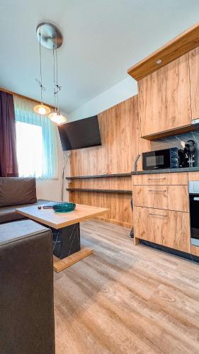 a living room with a table and a microwave at Sylpaulerhof Deluxe Apartment 8 in Sankt Michael im Lungau