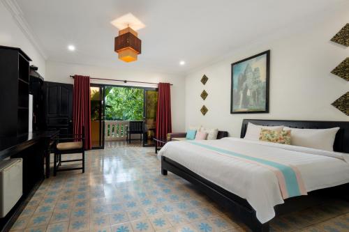 Ένα ή περισσότερα κρεβάτια σε δωμάτιο στο La Residence WatBo Hotel