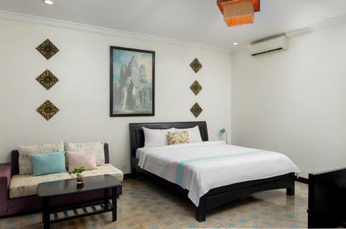 Ένα ή περισσότερα κρεβάτια σε δωμάτιο στο La Residence WatBo Hotel