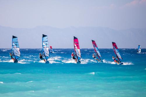 a group of people on sailboats in the ocean at Blue Horizon in Ialyssos