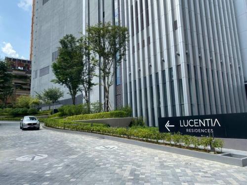 a car is parked in front of a building at 1BR condo with Amazing KLCC View & Infinity Pool at Lalaport Bukit Bintang in Kuala Lumpur