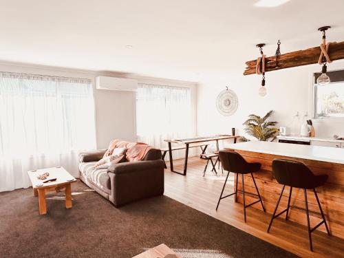 a living room with a couch and a table at Two One Two in Hokitika