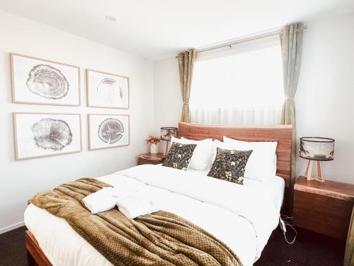 a bedroom with a large bed with a blanket on it at Two One Two in Hokitika