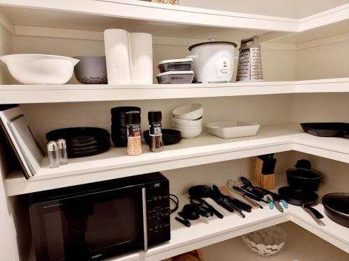 a kitchen pantry with a microwave and utensils at Maroochy City Lights@Thecosmopolitan Unit 20802 in Maroochydore
