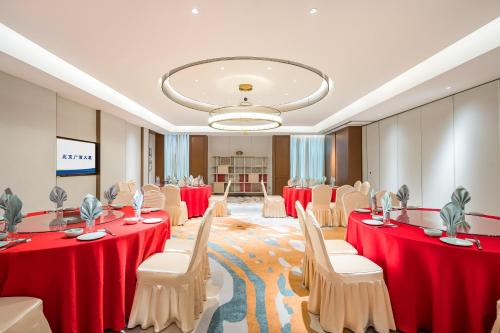 a conference room with red tables and chairs at Beijing Guangxi Hotel in Beijing