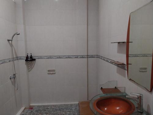 a bathroom with a shower and a toilet in it at Umah Kita in Seminyak