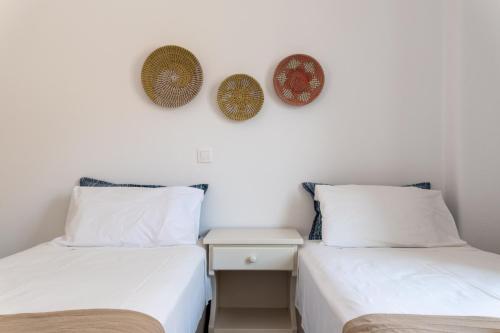 two beds sitting next to each other in a room at Sterna House Alkistis in Parikia