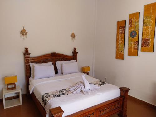 a bedroom with a bed with a towel on it at Umah Kita in Seminyak