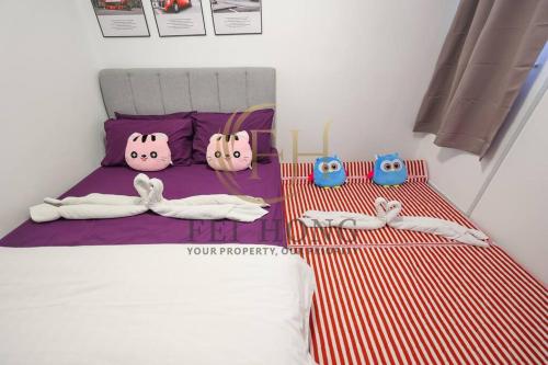 a bedroom with a bed with hello kitty items on it at Serdang Resort-Style Family Suite #Babycot #15 Pax in Seri Kembangan