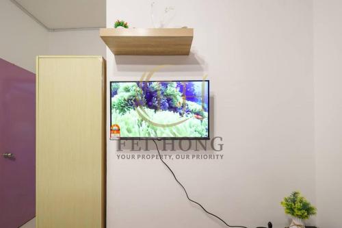 a sign on a wall with a picture of a flower at Serdang Resort-Style Family Suite #Babycot #15 Pax in Seri Kembangan