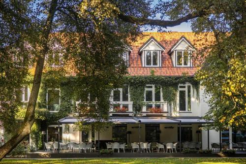a building with chairs and tables in front of it at Palanga Life Balance SPA Hotel in Palanga