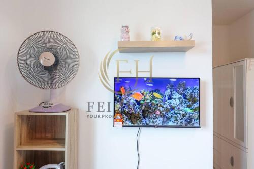 a living room with a fish tank on a wall at Serdang Resort-Style Family Suite #Babycot #15 Pax in Seri Kembangan