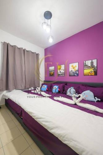 a purple bedroom with a bed with stuffed animals on it at Serdang Resort-Style Family Suite #Babycot #15 Pax in Seri Kembangan