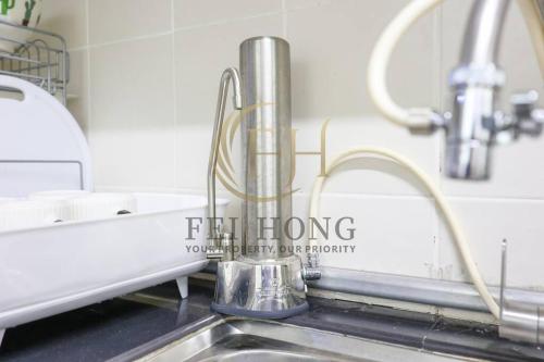 a kitchen sink with a chrome faucet at Serdang Resort-Style Family Suite #Babycot #15 Pax in Seri Kembangan