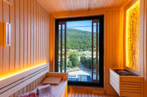a room with a window with a view of a mountain at Narven Wellness & Thermal Hotel in Yukarımahalle